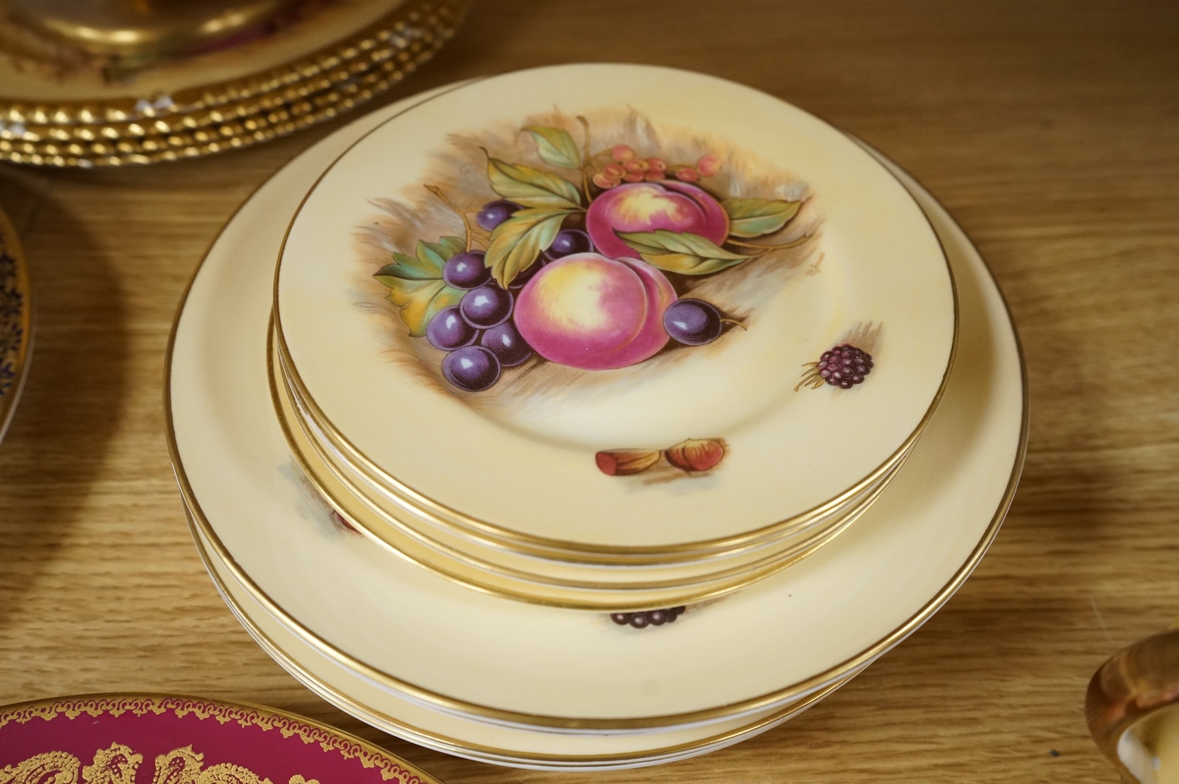 A collection of Aynsley ‘Orchard Gold’ fruit-painted tea/dinner wares and vases, largely signed by D Jones, largest 26cm in diameter